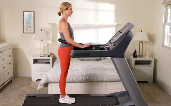 Woman standing upright on treadmill ready to start workout demonstrating proper posture while using Treadmill Max treadmill stability belt