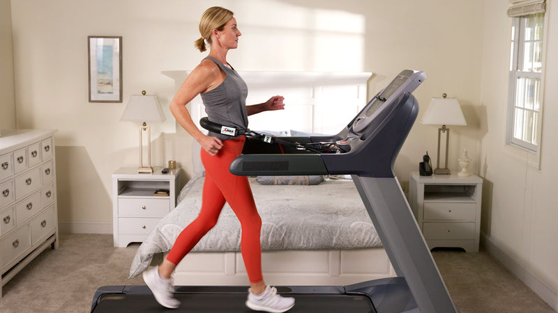 Woman running on treadmill using Treadmill Max treadmill stability belt